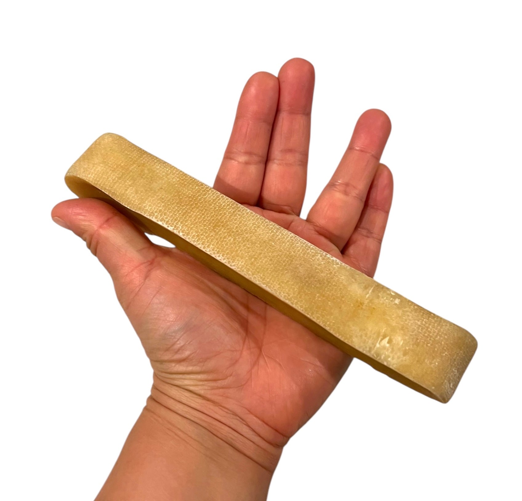 Hand holding a cheese chew for scale