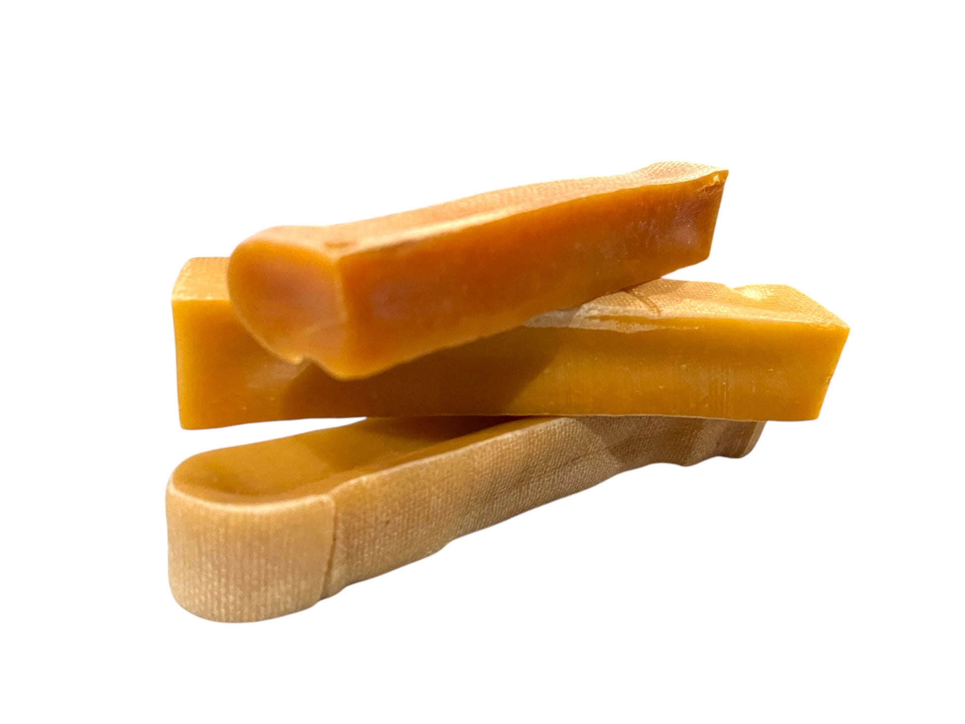 Three large rectangular dog chews, made out of dehydrated cheese curds, placed on top of the other.